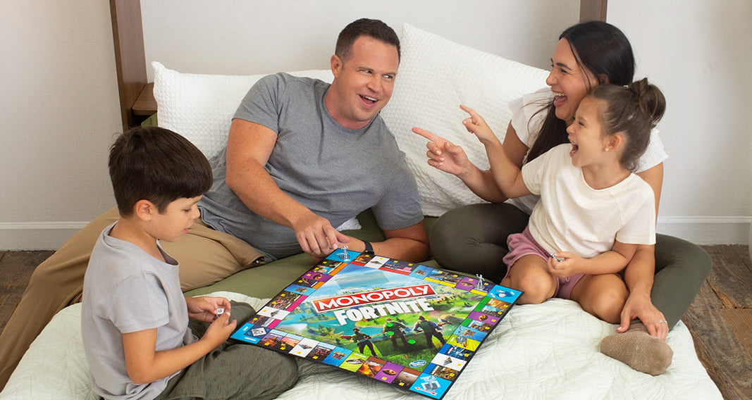 Family playing a board game on an open Lori Bed